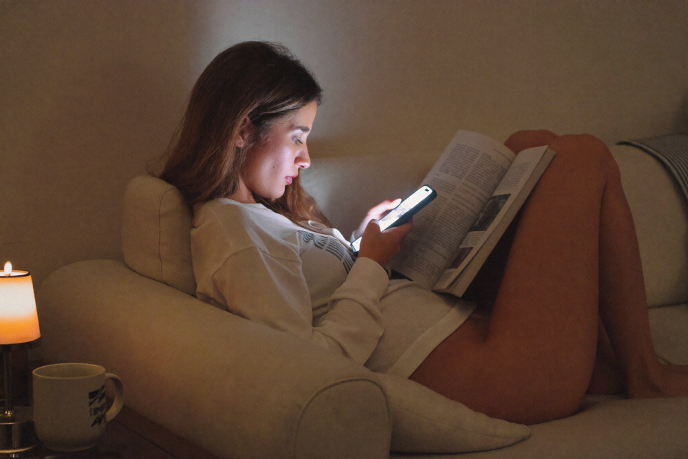 Woman researching hair care on her phone at night